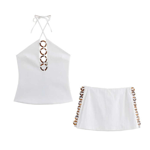 Accessories hanging neck short top, short skirt and pants set for women in white with decorative details.