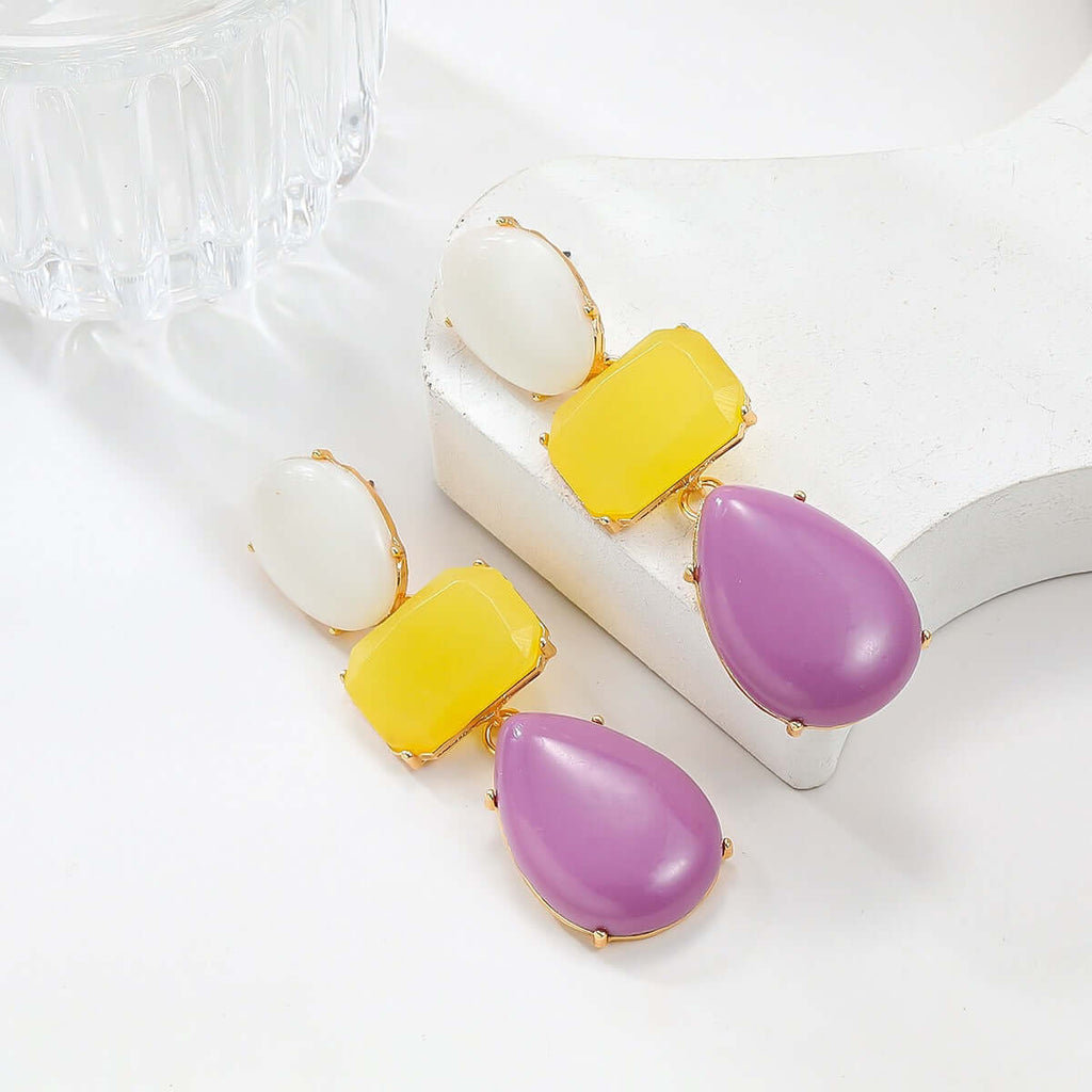 Colored resin earrings for women with Bohemian style exaggerated accessories on a display.
