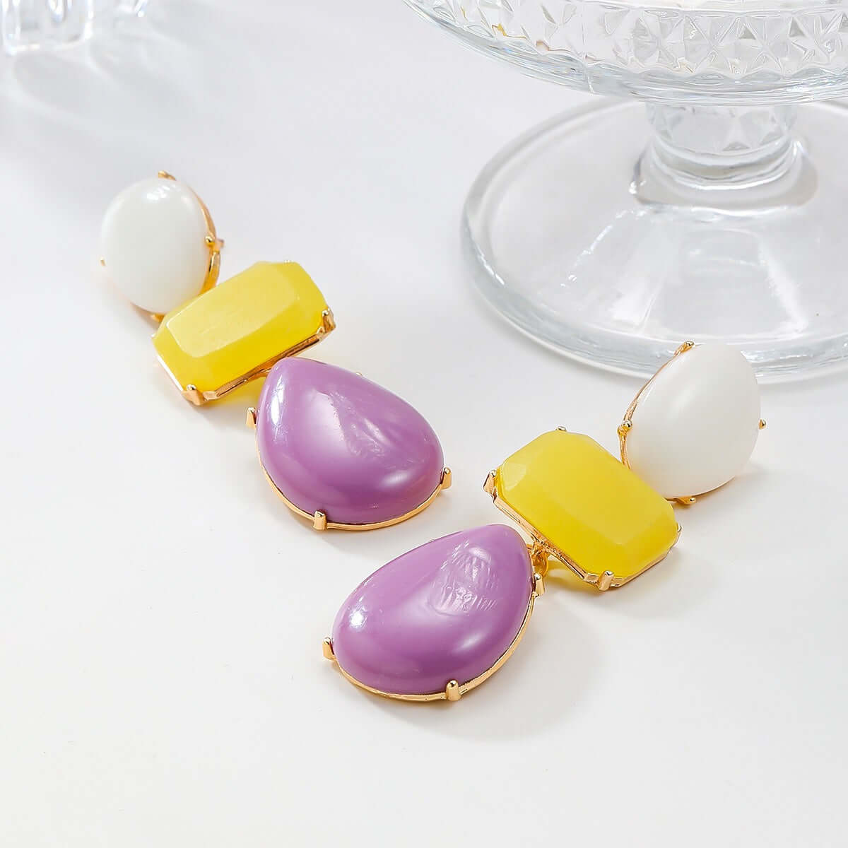 Colored resin earrings for women with Bohemian style exaggerated accessories in vibrant purple and yellow.