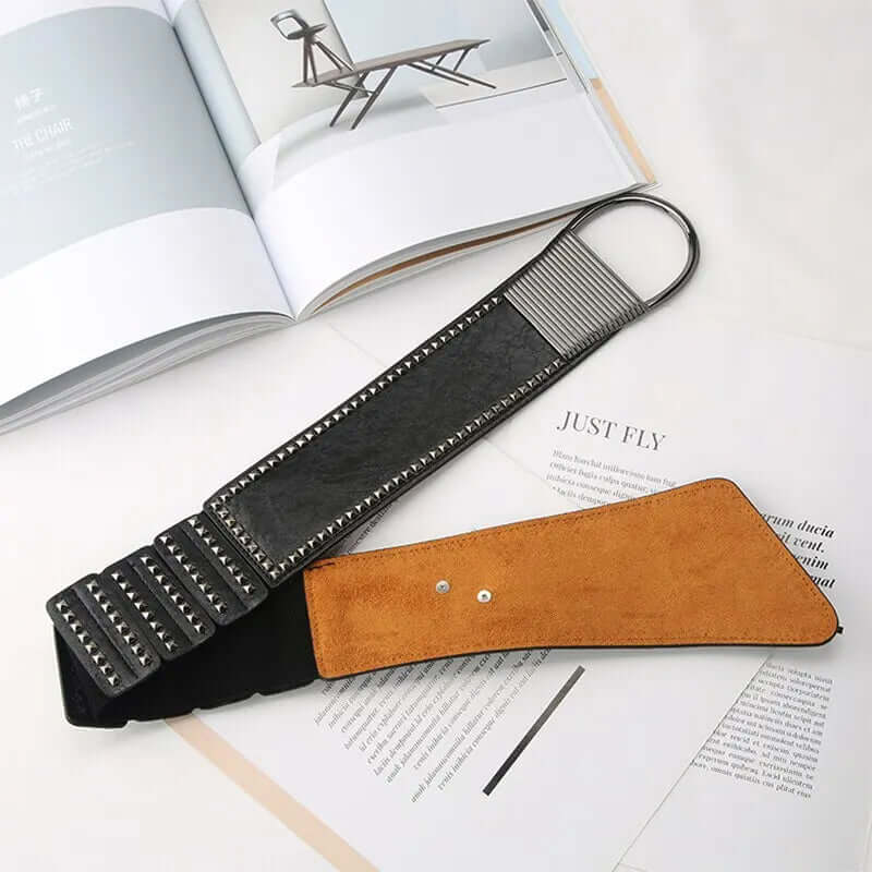 Gothic Style Liuding Dark Style Womens Plastic Waist Coat Dress Suit Womens Belt laid over open magazines.