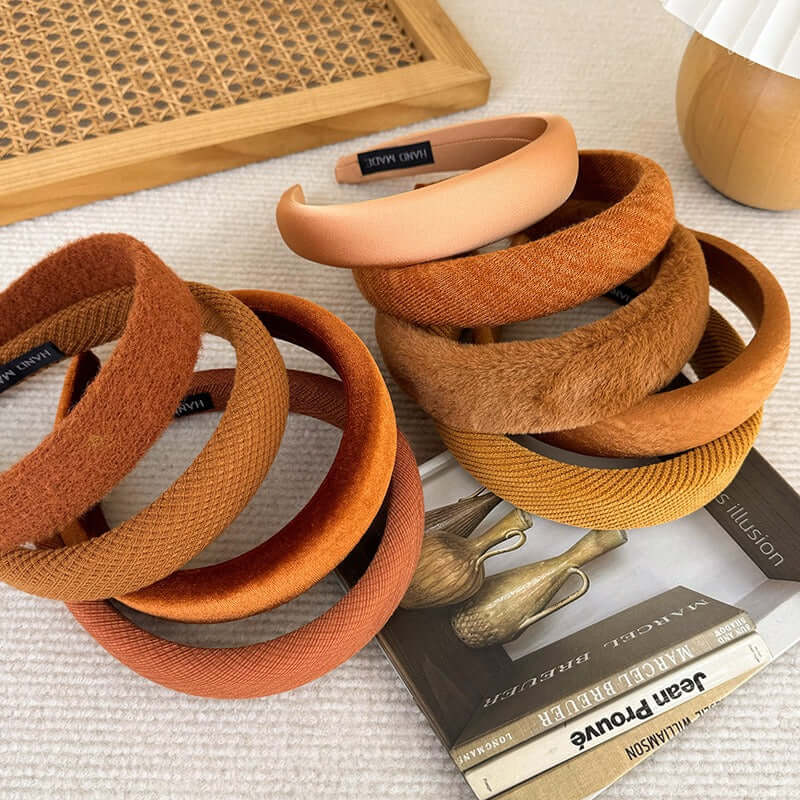 High-ceiling Maillard-colored headband for women with pressed hair accessories displayed on a table.
