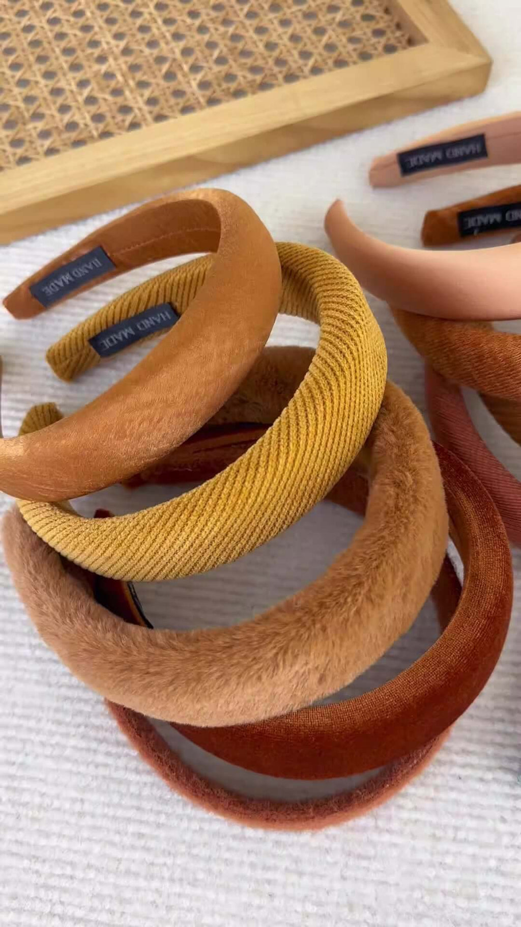 High-ceiling Maillard-colored headband for women with pressed hair accessories stacked together.