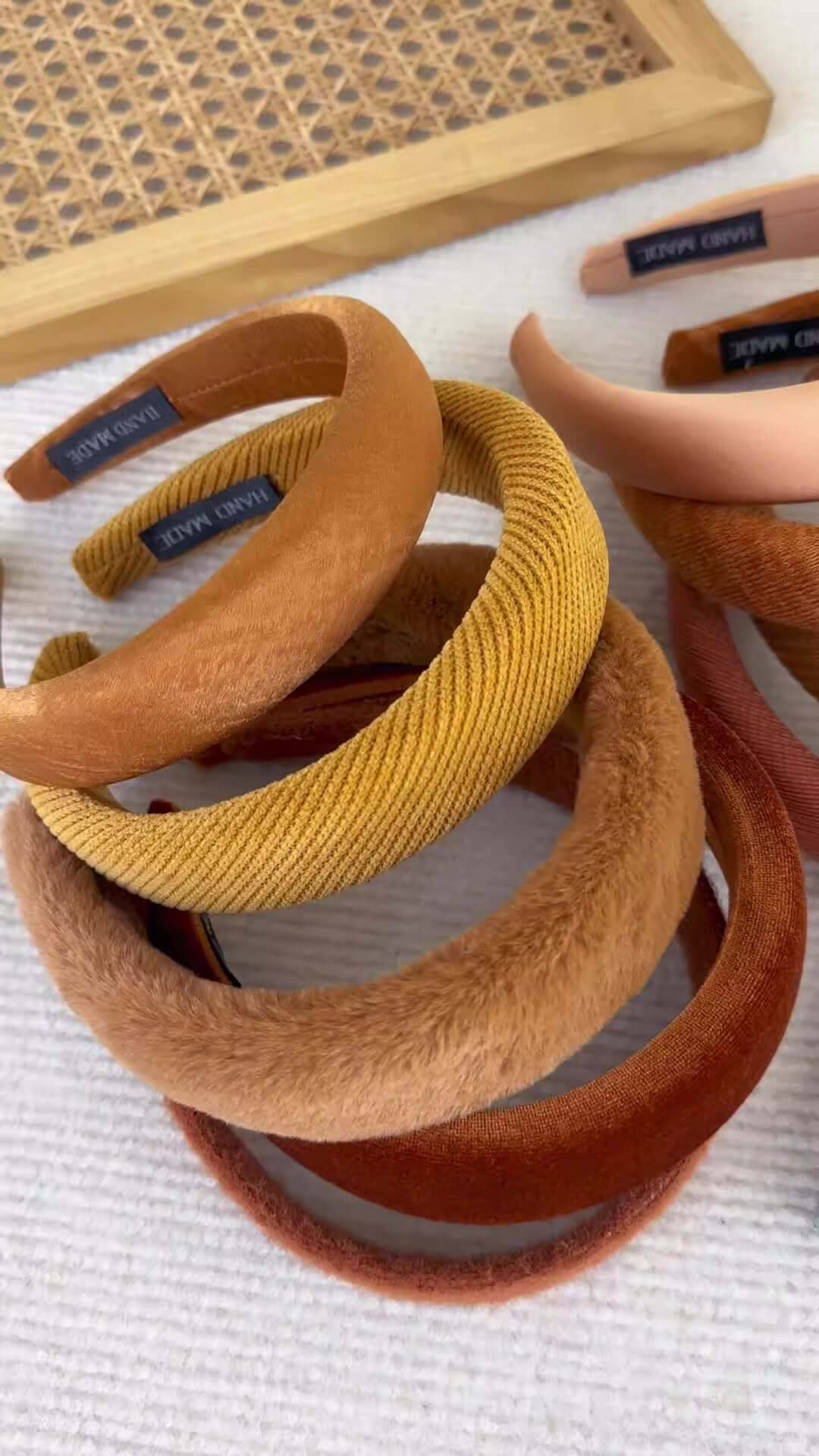 High-ceiling Maillard-colored headband for women with pressed hair accessories stacked together.