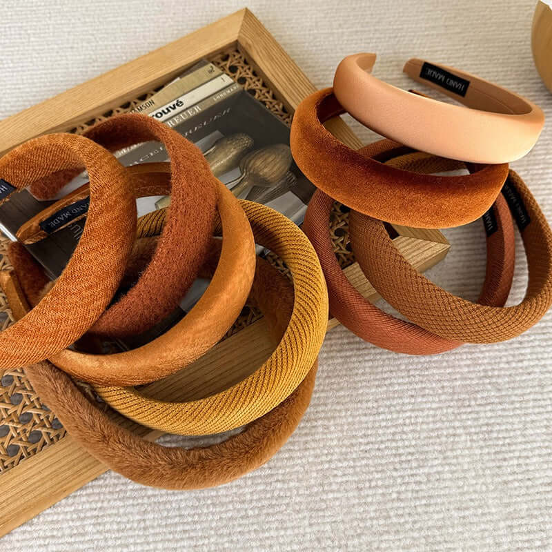 High-ceiling Maillard-colored headband for women with pressed hair accessories displayed on a textured surface.